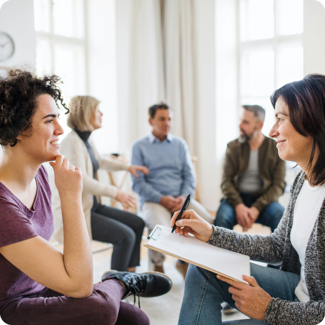 group of people sitting together and counselor taking notes