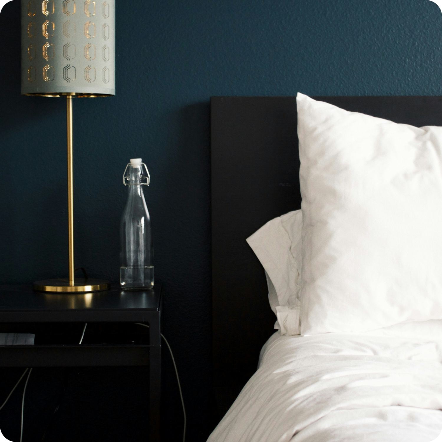 closeup image of bed and nightstand table