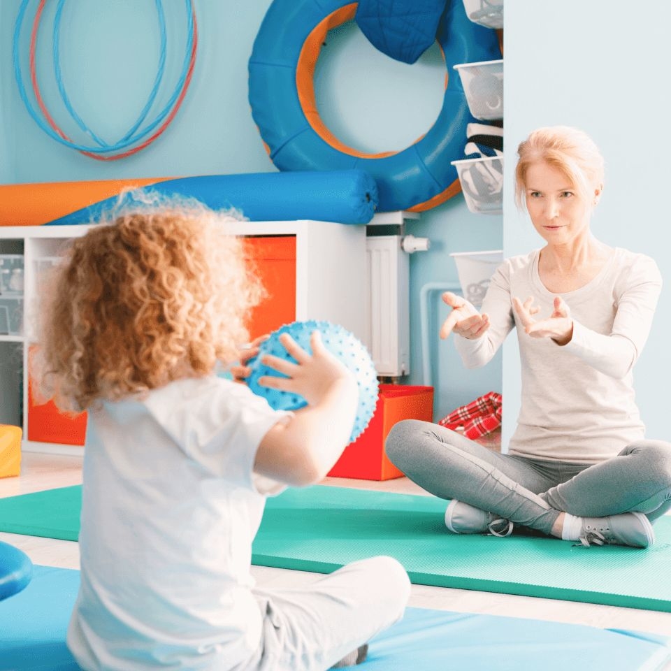 Female pediatric OT doing an occupational therapy assessment during a session 