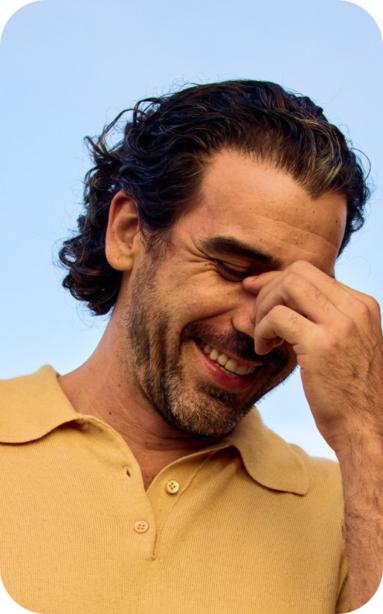 main smiling with hand on nose