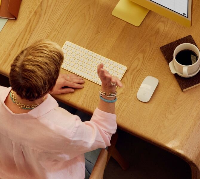 woman sitting at a desk on a telehealth call