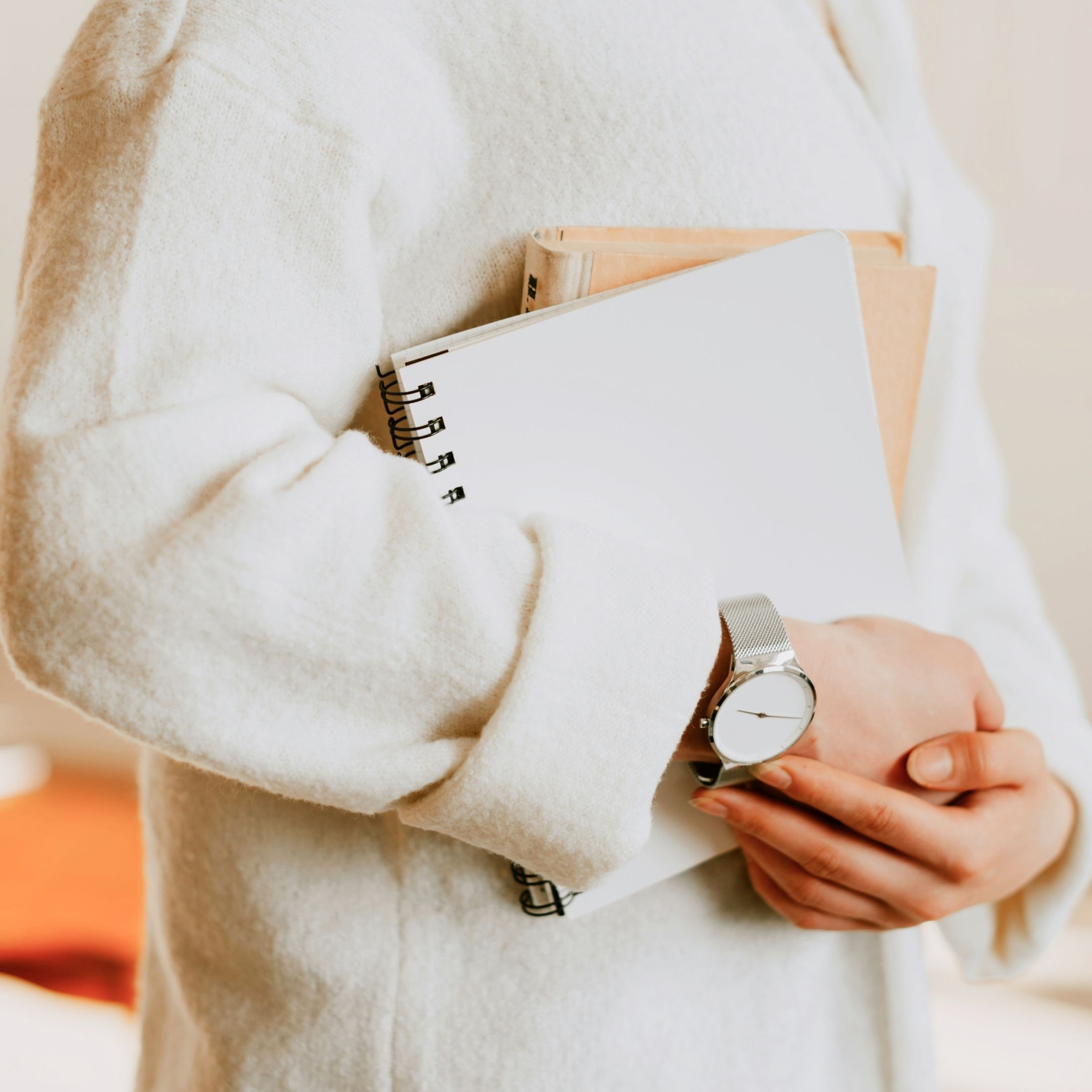 close up of person holding notebooks