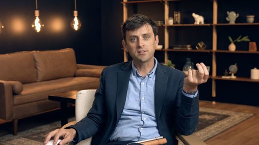 man wearing a button down in a chair for an interview