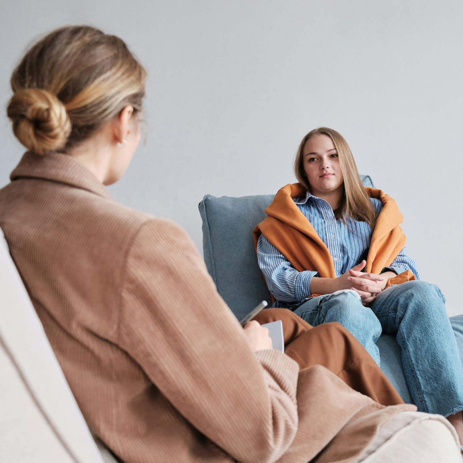SLP providing client with stuttering therapy resources