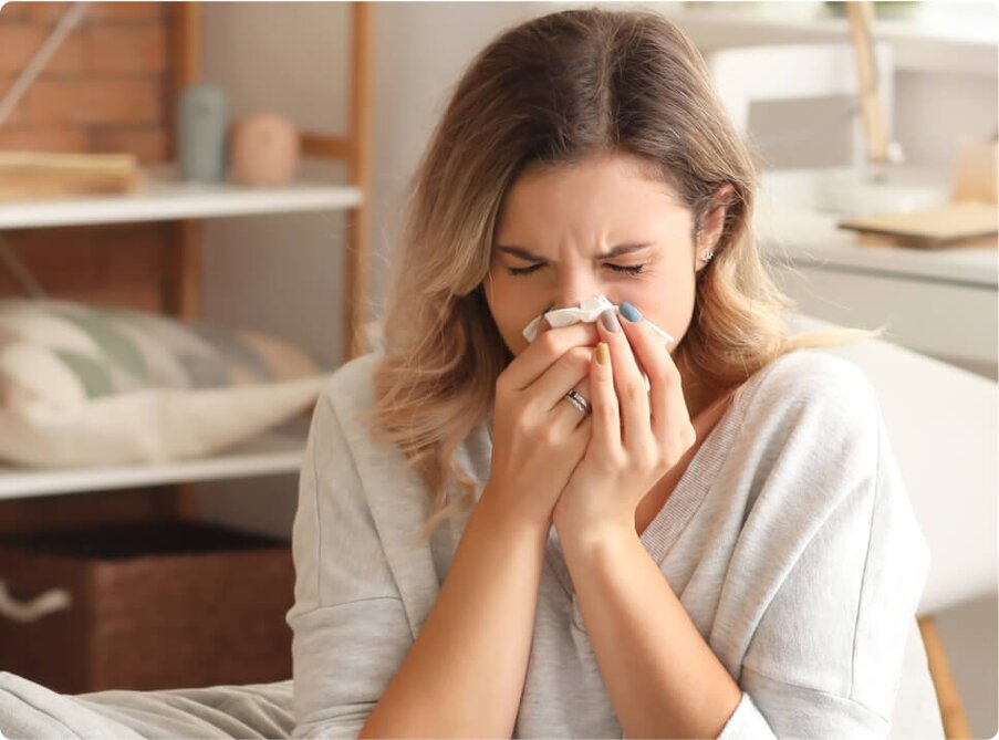 woman sneezing from allergies