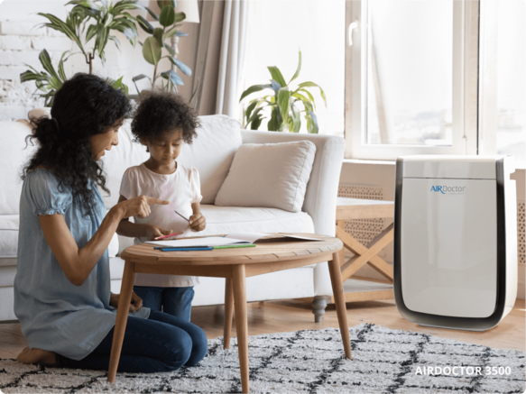 Mom and daughter in living with AirDoctor purifier