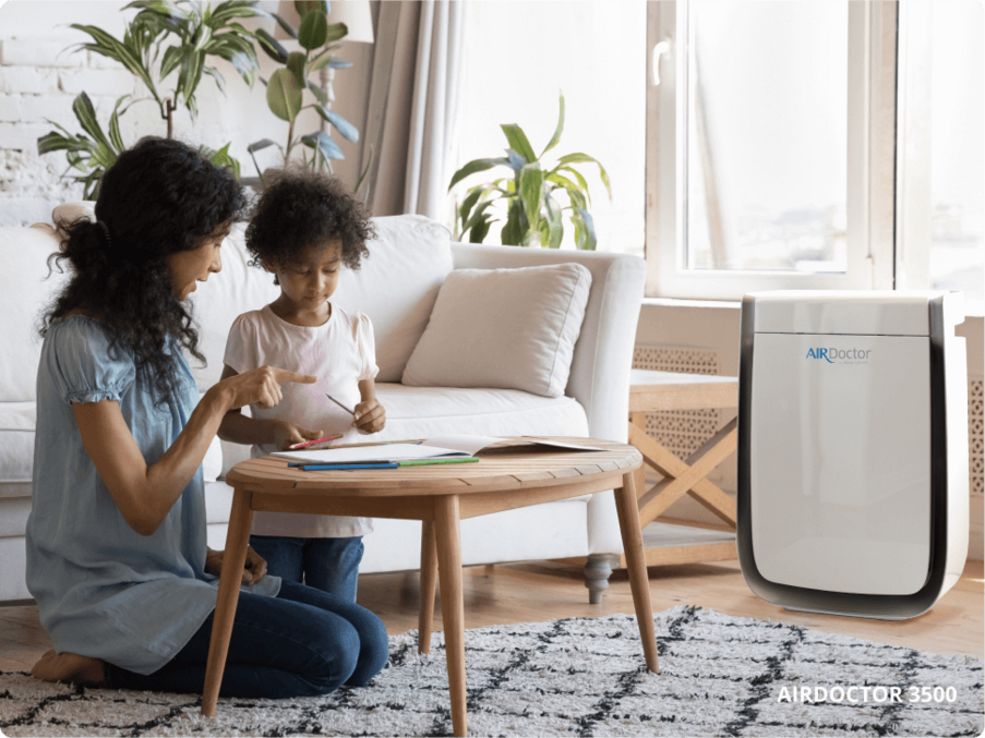 Mom and daughter in living with AirDoctor purifier