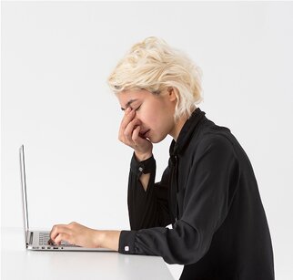 woman on laptop sinus pain