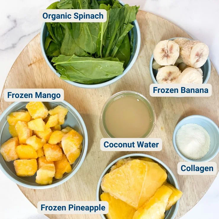 Top view image of Tropical Greens Smoothie ingredients with text over each ingredient.