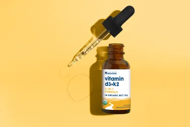 A bottle of NativePath Vitamin D3+K2 tincture on a yellow background