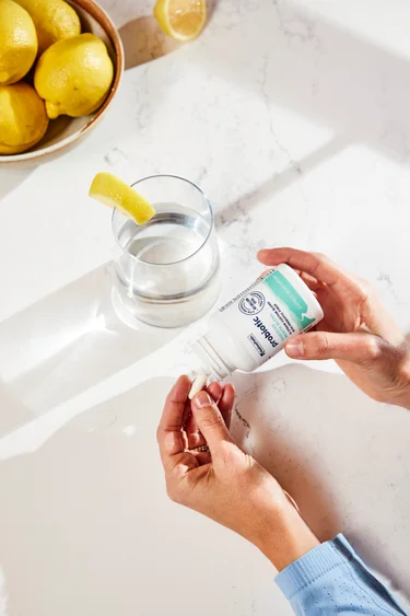 A bottle of NativePath Probiotic with capsules next to it