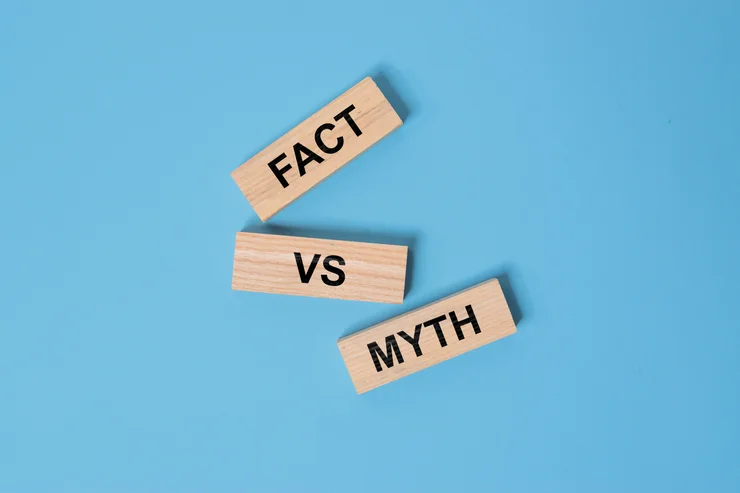 Fact vs Myth written on wooden blocks on a plain blue background