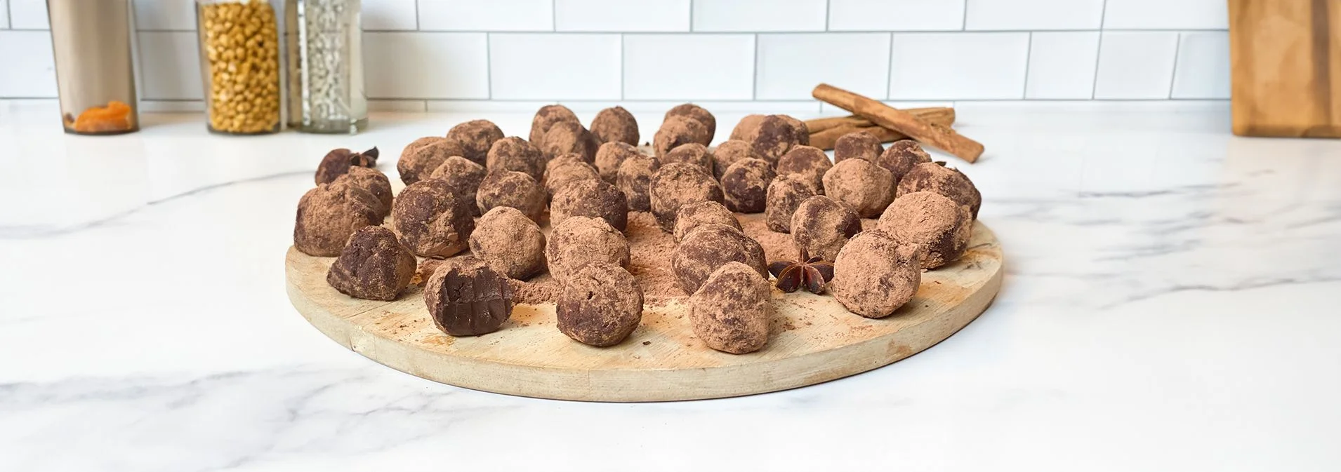 Front view of Paleo Spiced Chai Truffles arranged on a circular wooden board.