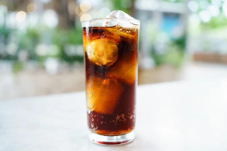 A glass filled with ice and soda