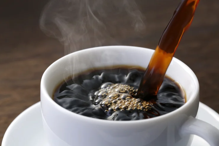 Cup of coffee being poured