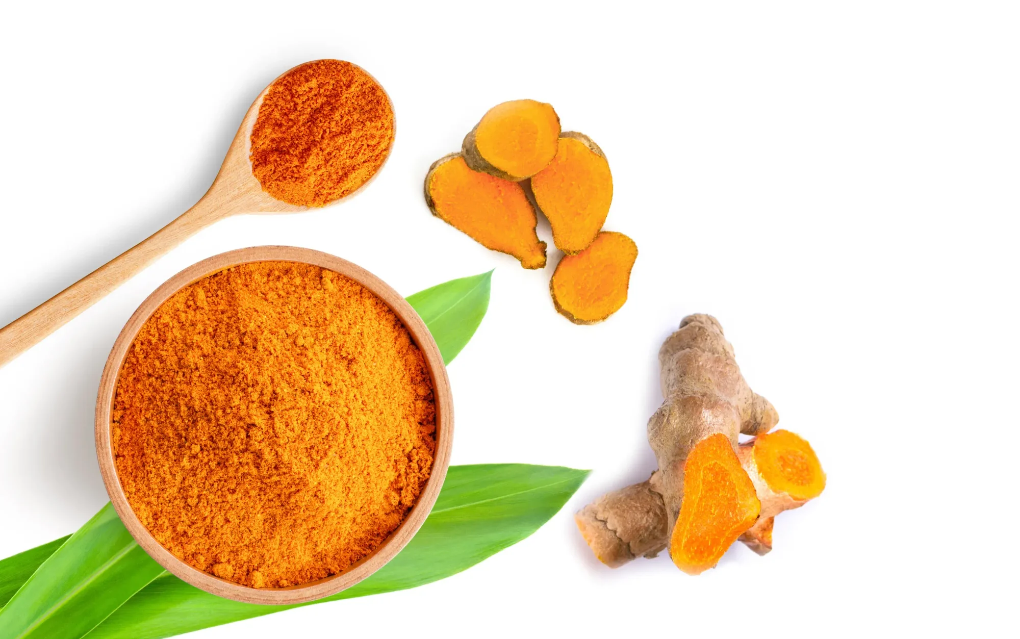 Turmeric powder (curcumin, Curcuma longa Linn) in a wooden bowl and spoon with turmeric isolated on white background. Top view. Flat lay.