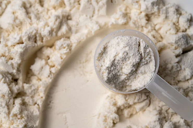 A scoop of creatine on top of creatine powder