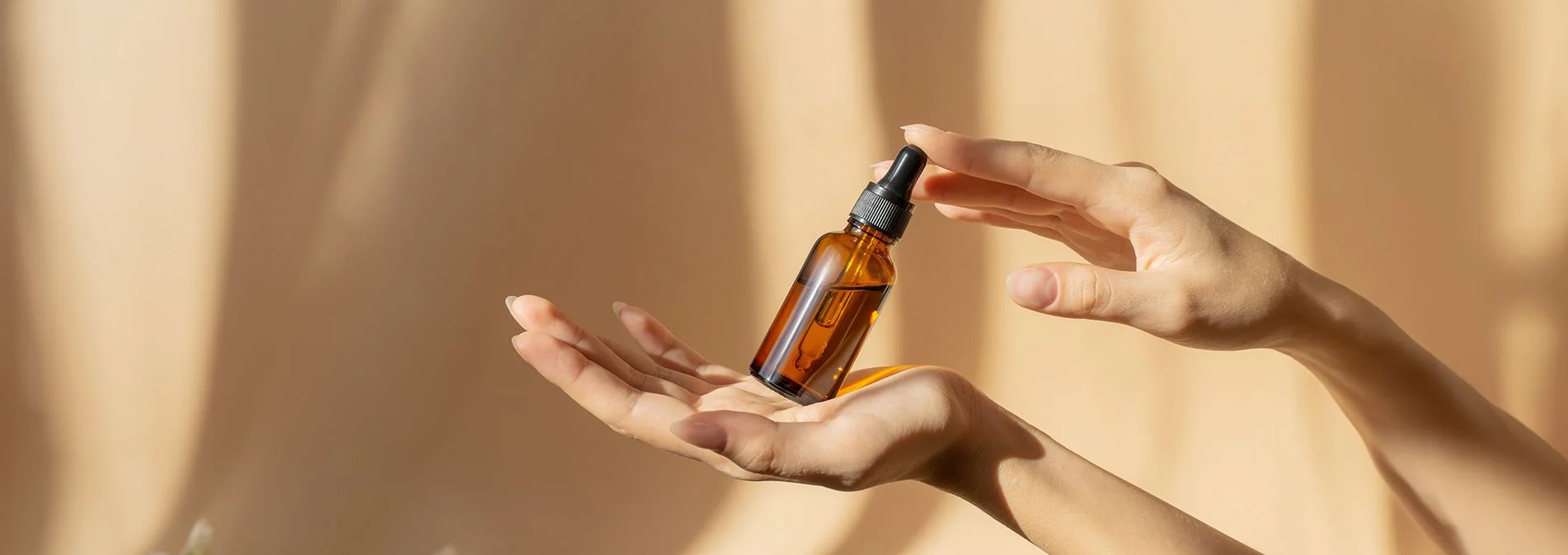 A bottle of NativePath Vitamin D3+K2 tincture with the dropper and packaging on a kitchen counter with a tile background