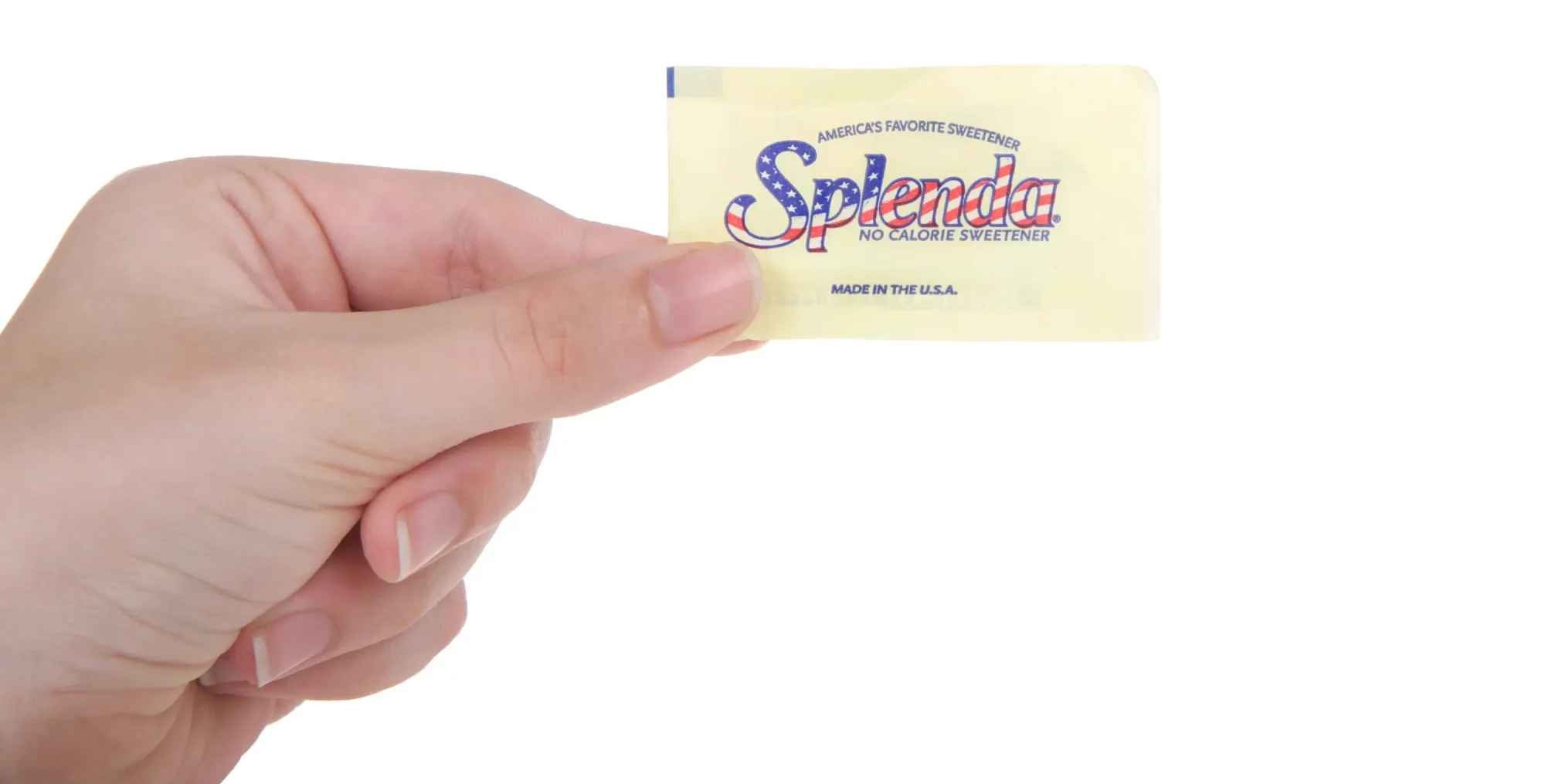Hand holding a packet of Splenda artificial sweetener. Isolated on white background.