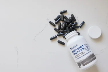 A bottle of NativePath Activated Charcoal with pills spilling out