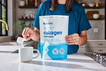 A woman pouring a scoop of NAtivePath Original Collagen Peptides from the 56 serving bag into a coffee mug