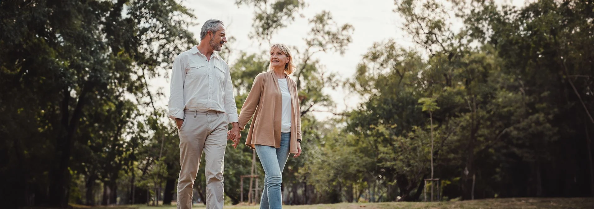 A happy older couple walking in the woods