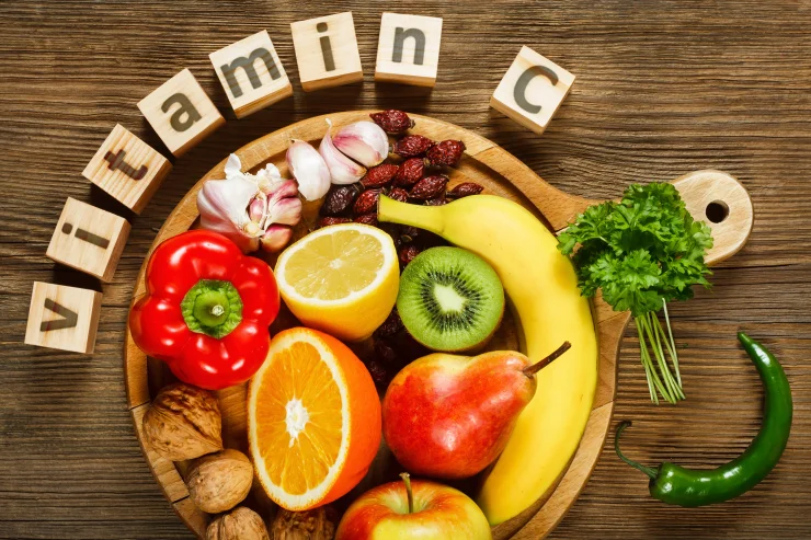 Vitamin C in fruits and vegetables. Natural products rich in vitamin C as oranges, lemons, dried fruits rose, red pepper, kiwi, parsley leaves, garlic, bananas, pears, apples, walnuts, chili