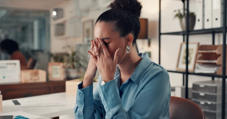 A woman experiencing negative self-talk, stress, and burnout