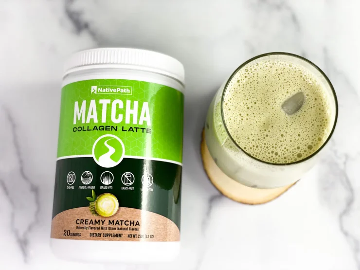 Top view of foamy iced Matcha Collagen Latte alongside a NativePath Matcha Collagen Jar.