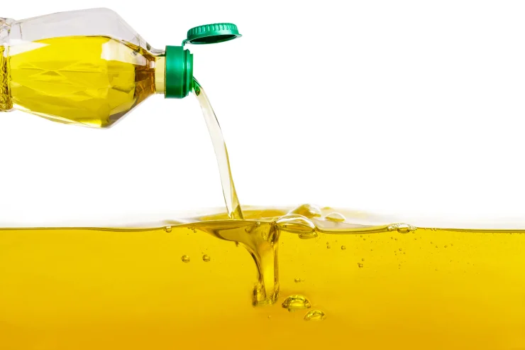 Pouring a bottle of vegetable oil