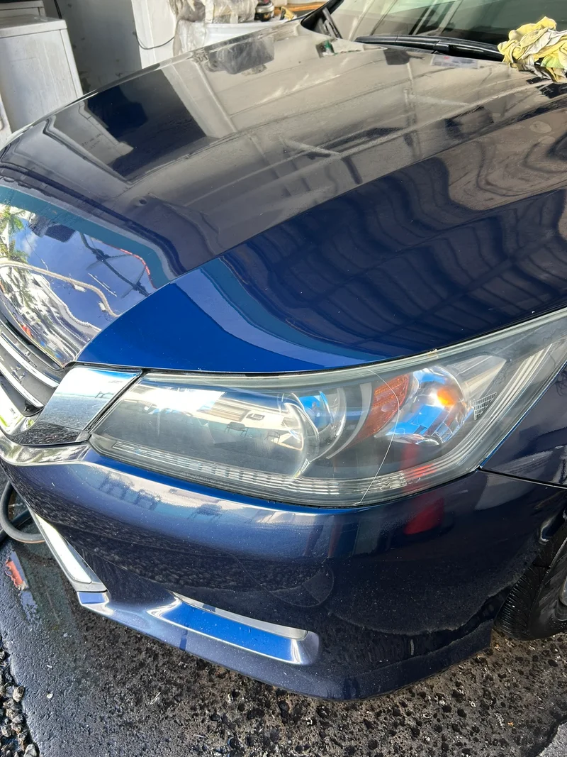 Blue sedan headlight after restoration