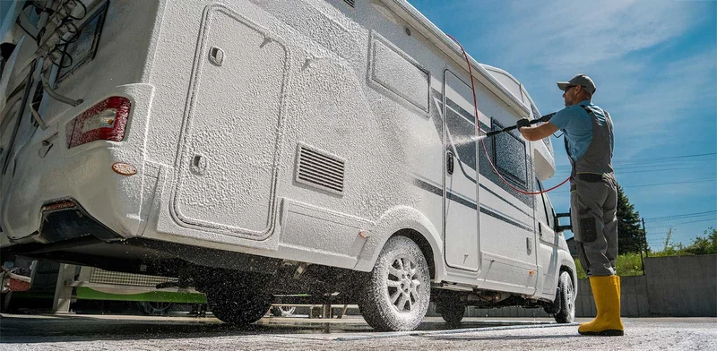 Pressure rinsing foam off a white motorhome