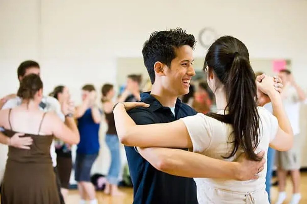 Couple dancing in a studio with other pairs