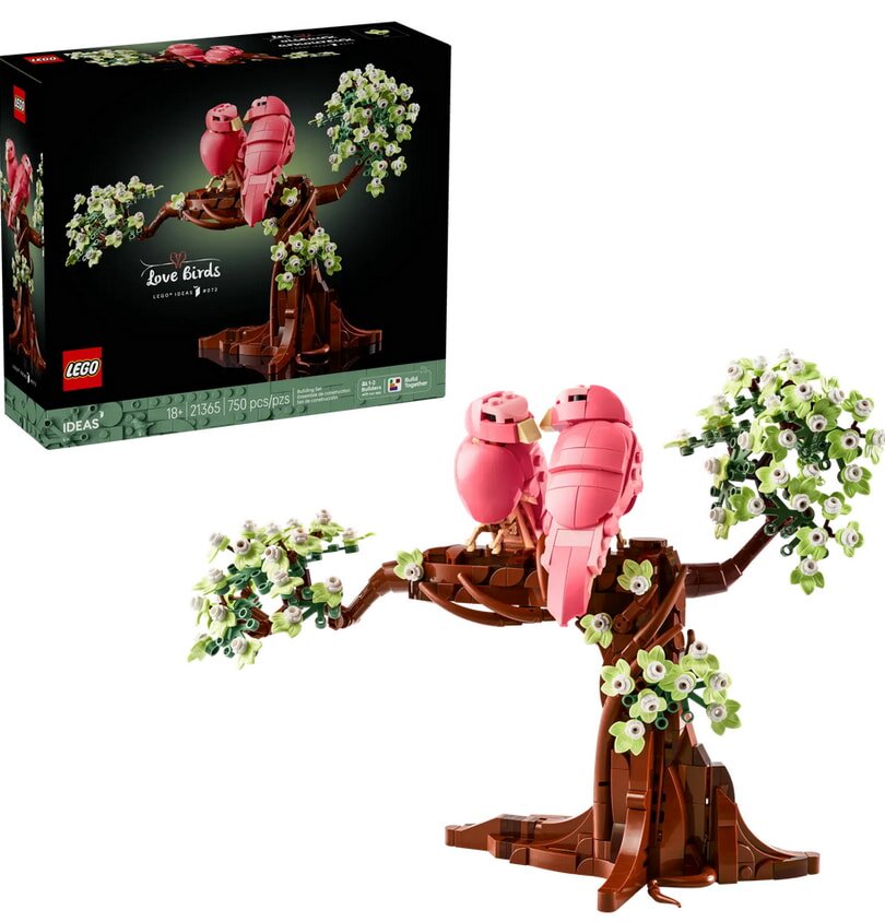 A pink bird perched on a tree branch next to a colorful box of LEGO bricks.