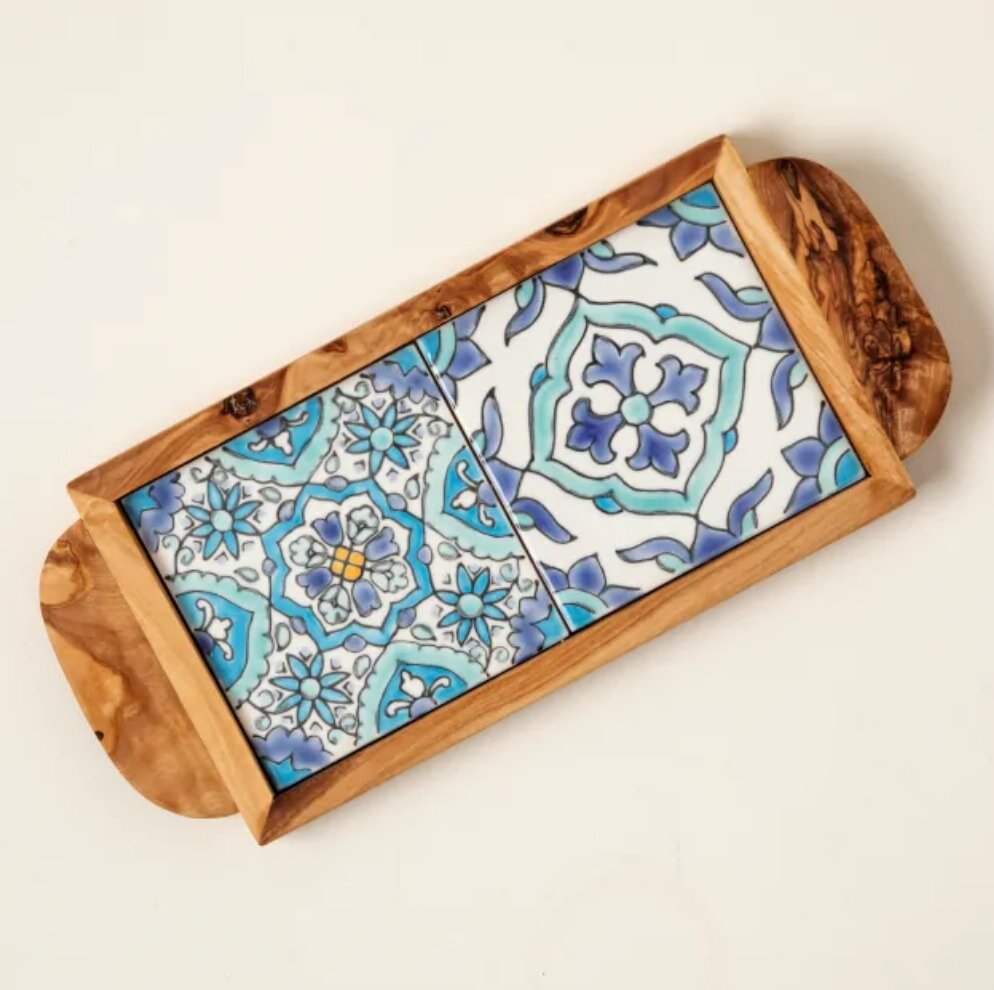 Wooden serving tray with two colorful tiles, featuring intricate blue floral patterns and geometric designs. The style is elegant and Mediterranean.