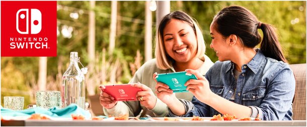 Two women sit at a table, engaged in a game on a Nintendo Switch console between them.