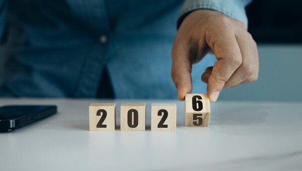 A busy mall filled with shoppers browsing various stores and interacting in a lively atmosphere.