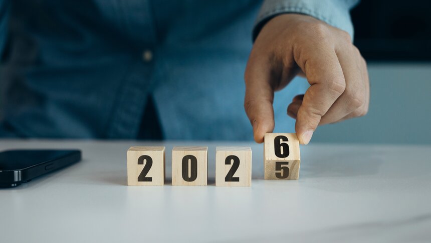 A group of people wearing festive Christmas outfits and hats, smiling and celebrating together in a joyful atmosphere.