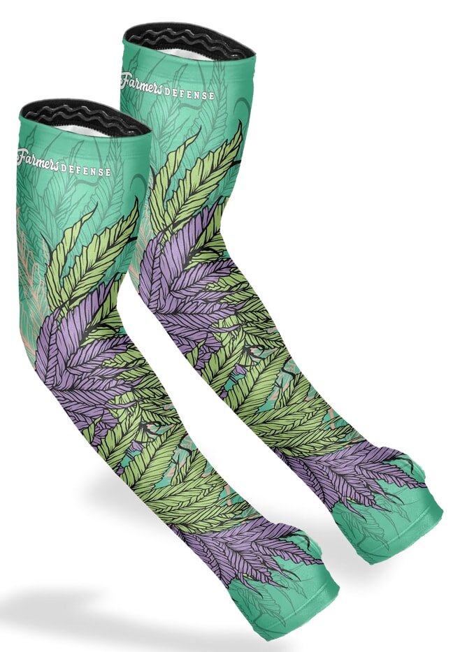 Green and purple arm sleeves featuring a design of leaves and flowers, showcasing a vibrant nature-inspired pattern.