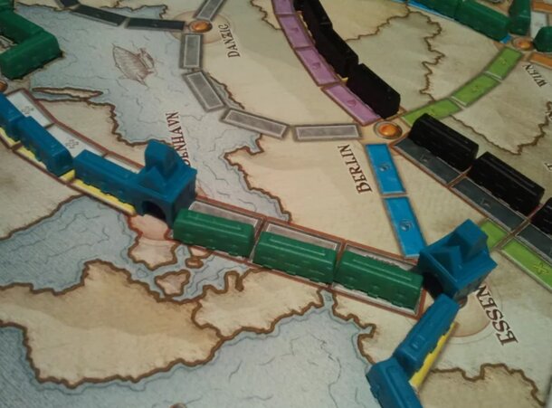A colorful board game featuring a detailed train track layout for players to navigate and strategize.