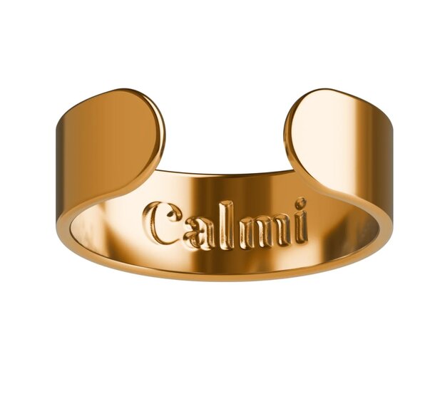 A gold ring featuring the engraved word "calmini" prominently displayed on its surface.