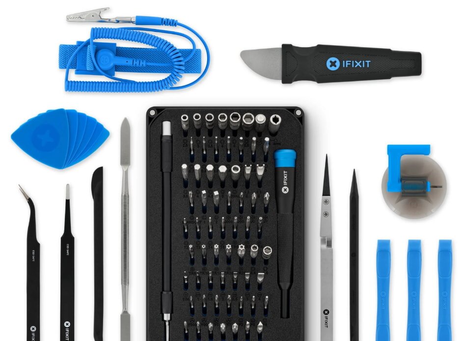 A hand holds a stained glass piece depicting a lit, intricate fantasy city at night. The backdrop features a starry sky and a crescent moon. In the background, blurred books and a small dragon figurine add to the mystical atmosphere.