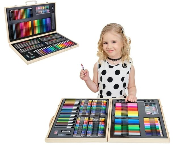A young girl smiles while holding a box filled with a vibrant assortment of colored pencils.