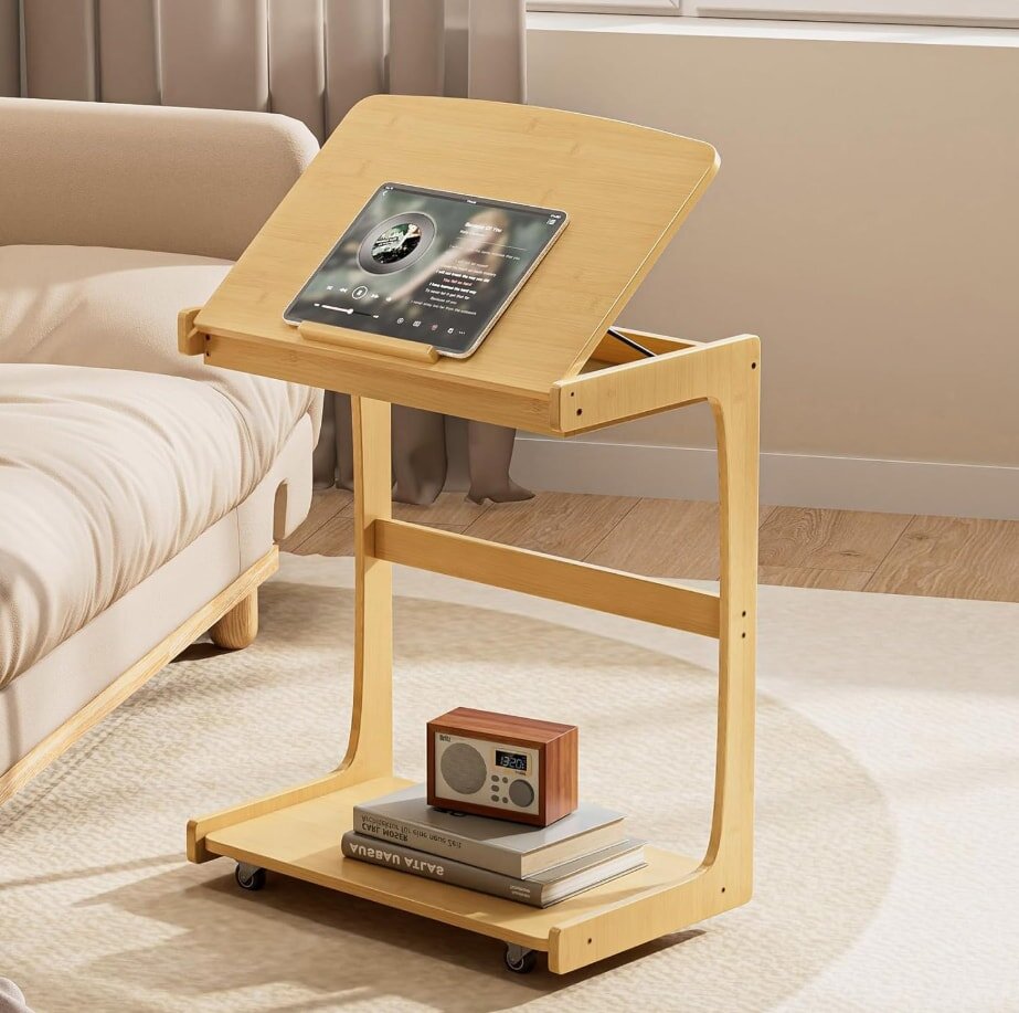 A green tray holding rows of small seedlings is placed on a wooden table outdoors. In front, there are seed packets for sunflower, bell pepper, and cilantro.