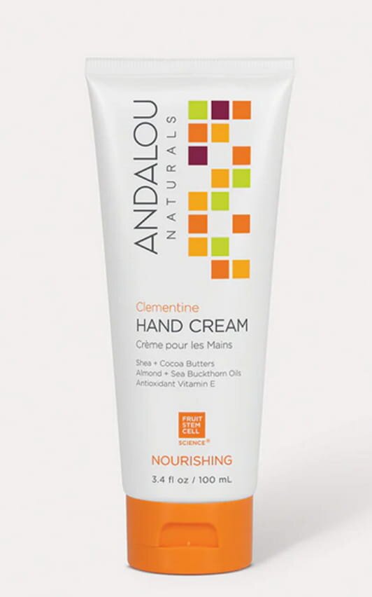 Andalou hand cream featuring orange and lemon scents, presented in a sleek container on a neutral background.