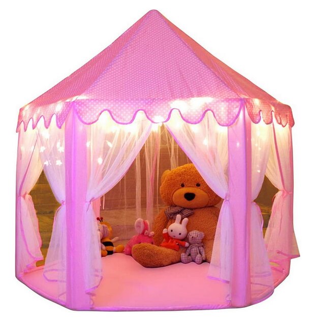 A pink tent with a teddy bear sitting inside, creating a cozy and playful atmosphere.