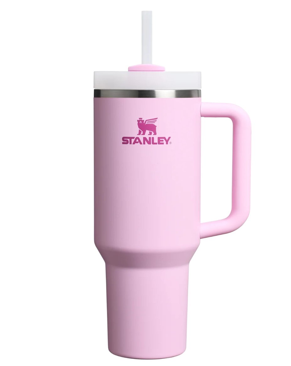 A pink Stanley tumbler with a convenient handle, designed for easy carrying and sipping.