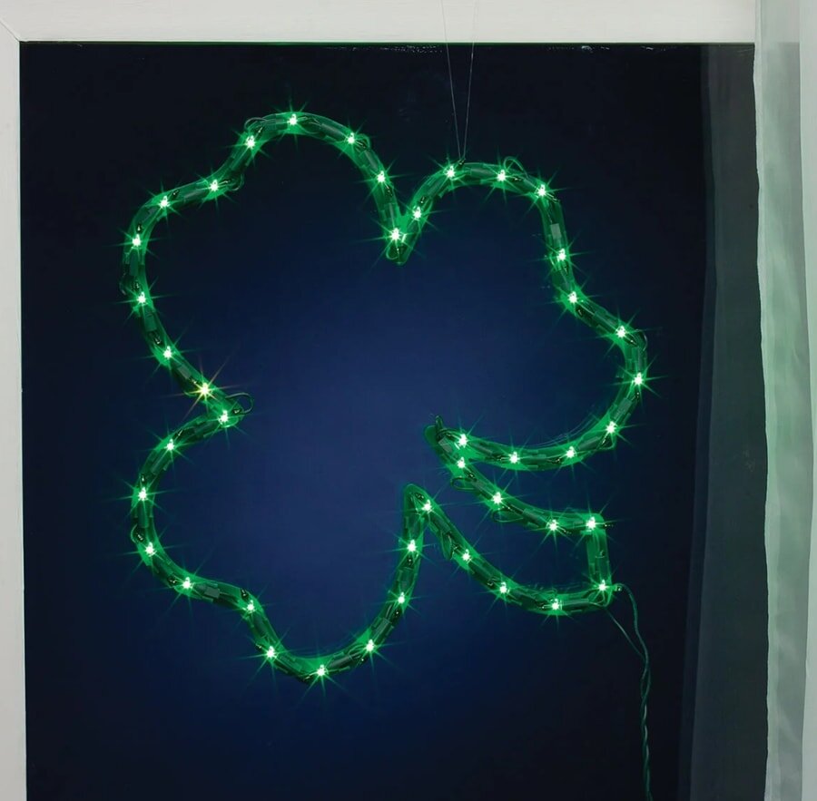 A green shamrock-shaped light fixture is hanging from a wall, adding a festive touch to the decor.