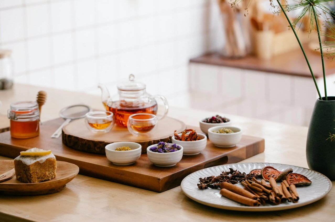A table set with an assortment of tea and various food items, inviting for a cozy gathering or afternoon tea.