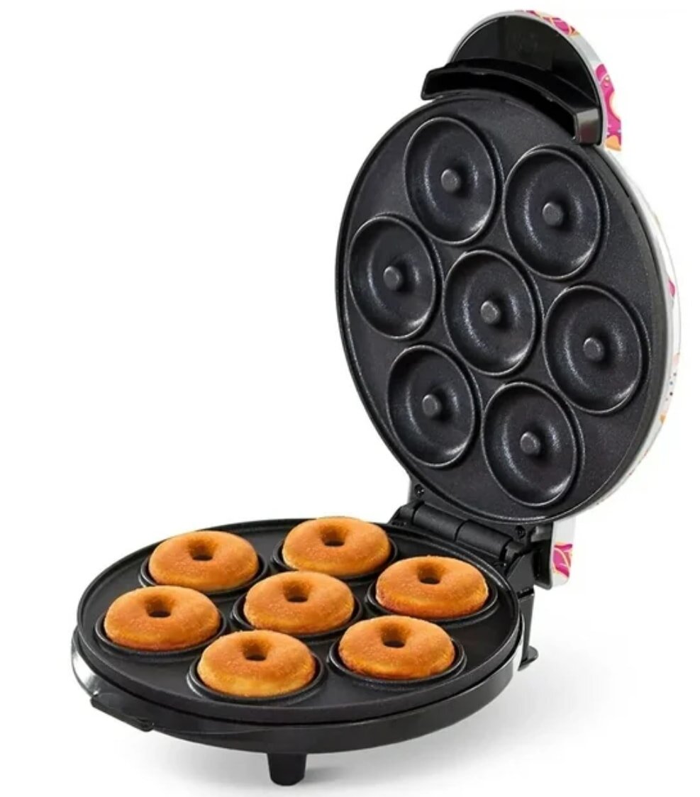 A donut maker filled with six freshly baked donuts, showcasing their golden-brown color and round shape.